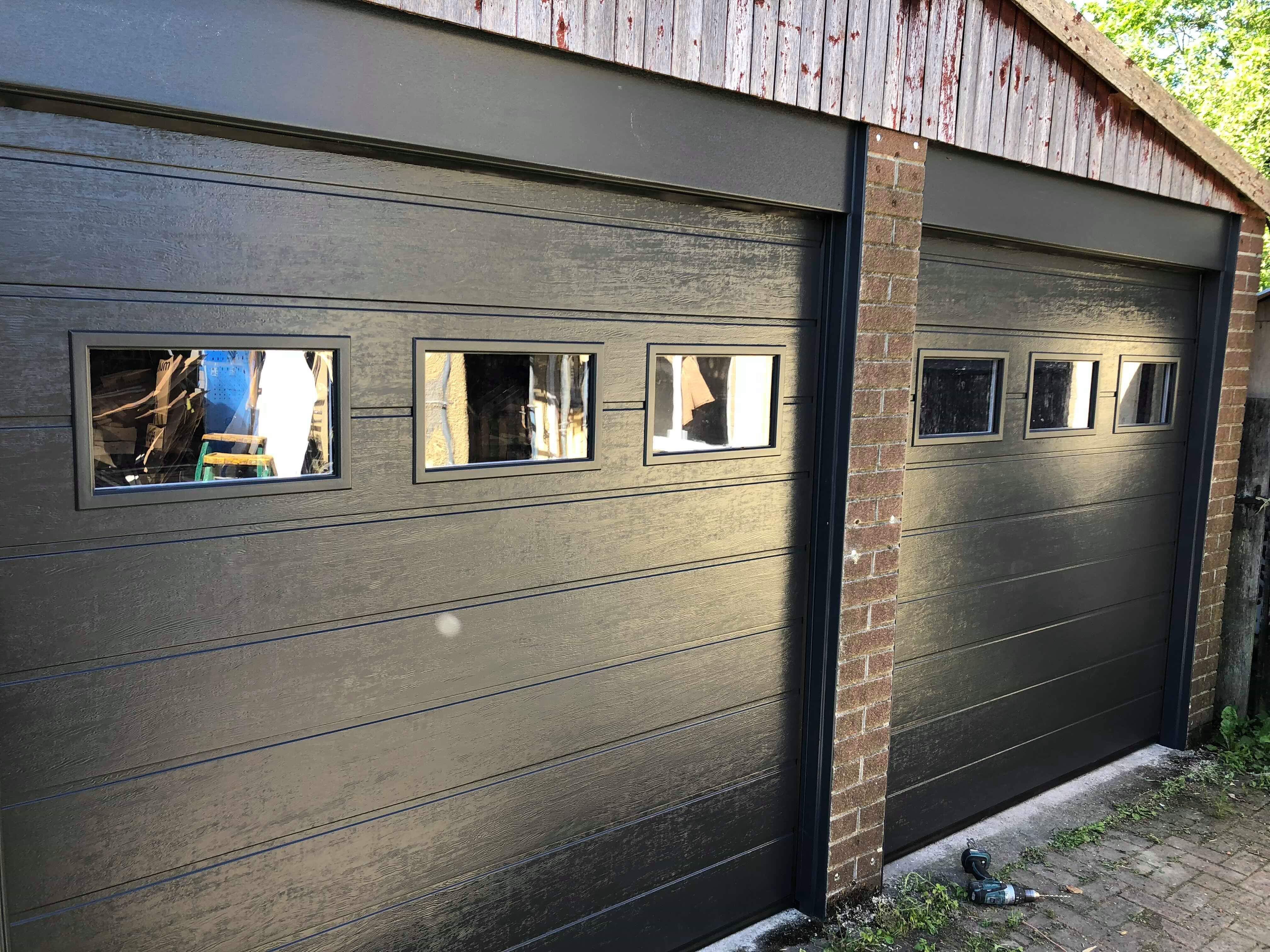 Two sectional garage doors in RAL colour with windows